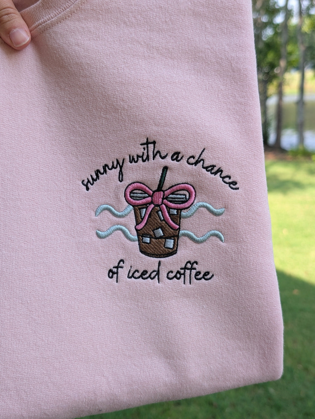 Embroidered iced coffee sweatshirt detail shot outdoors
