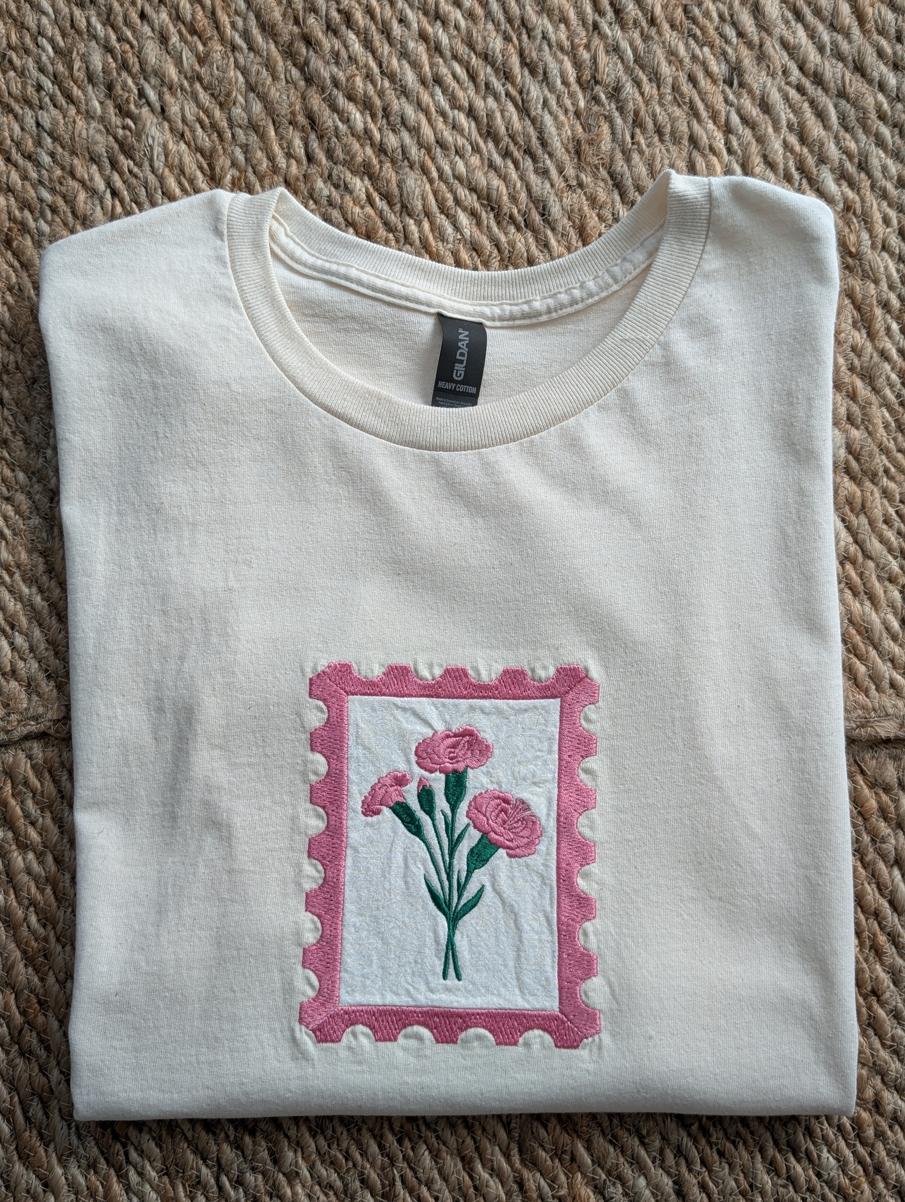 Comfort Colors cream women's tee with embroidered pink carnation postage stamp applique