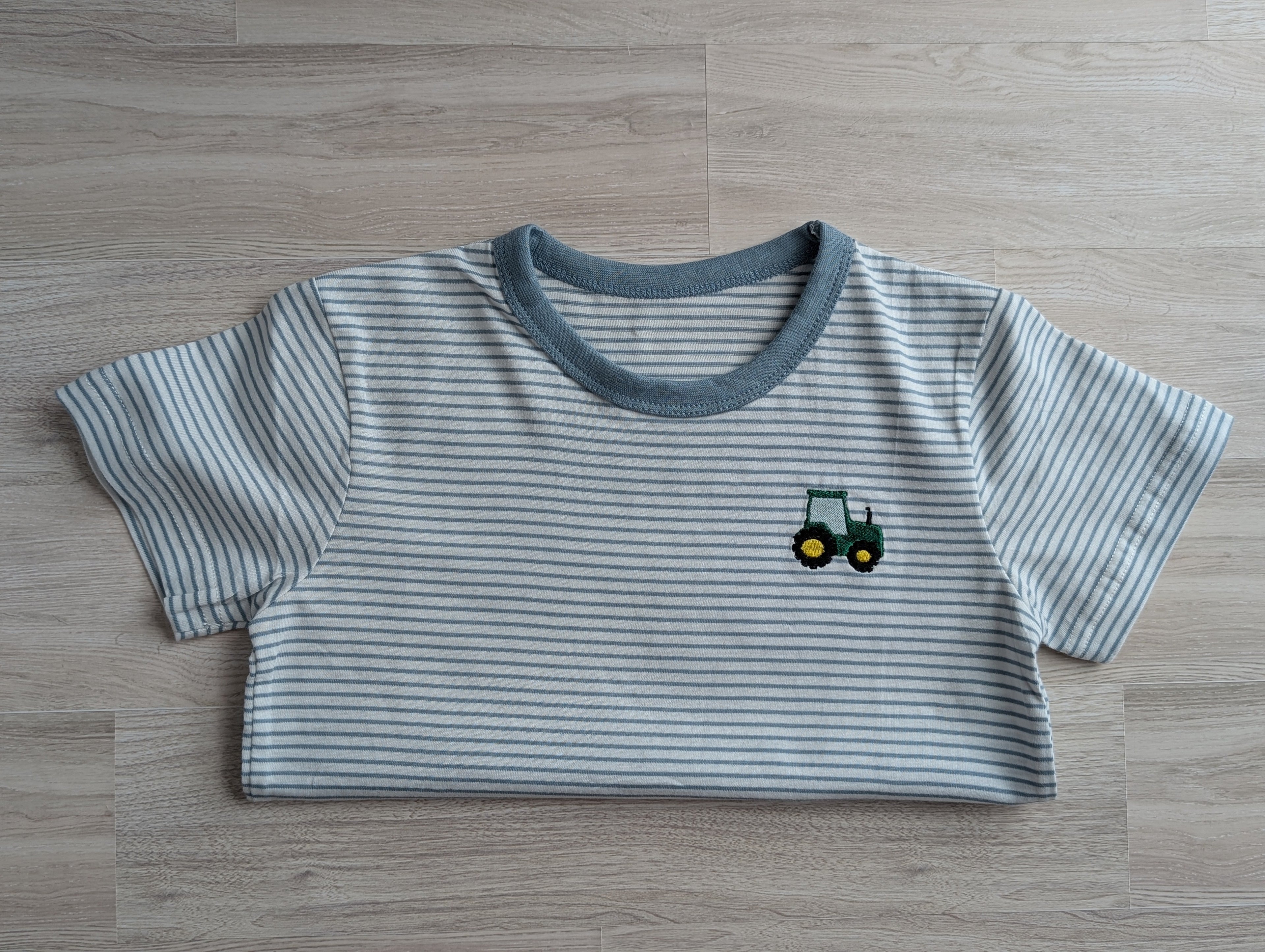 Blue grey and white stripe boys tee with embroidered tractor logo on chest