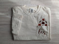 Folded cream Comfort Colors pocket tee with fall leaf and monogram embroidery