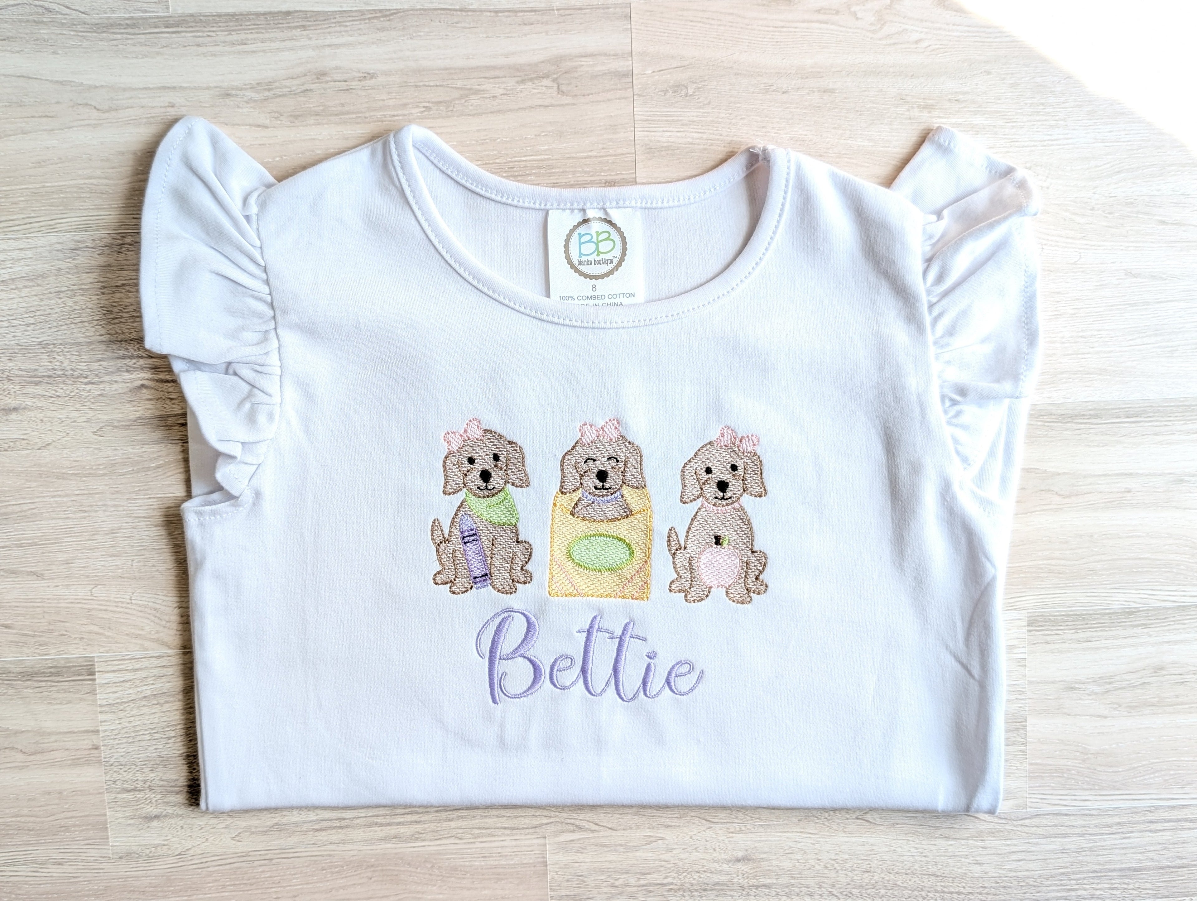 Puppy trio embroidered personalized tees, Stella and Bettie, folded flat lay