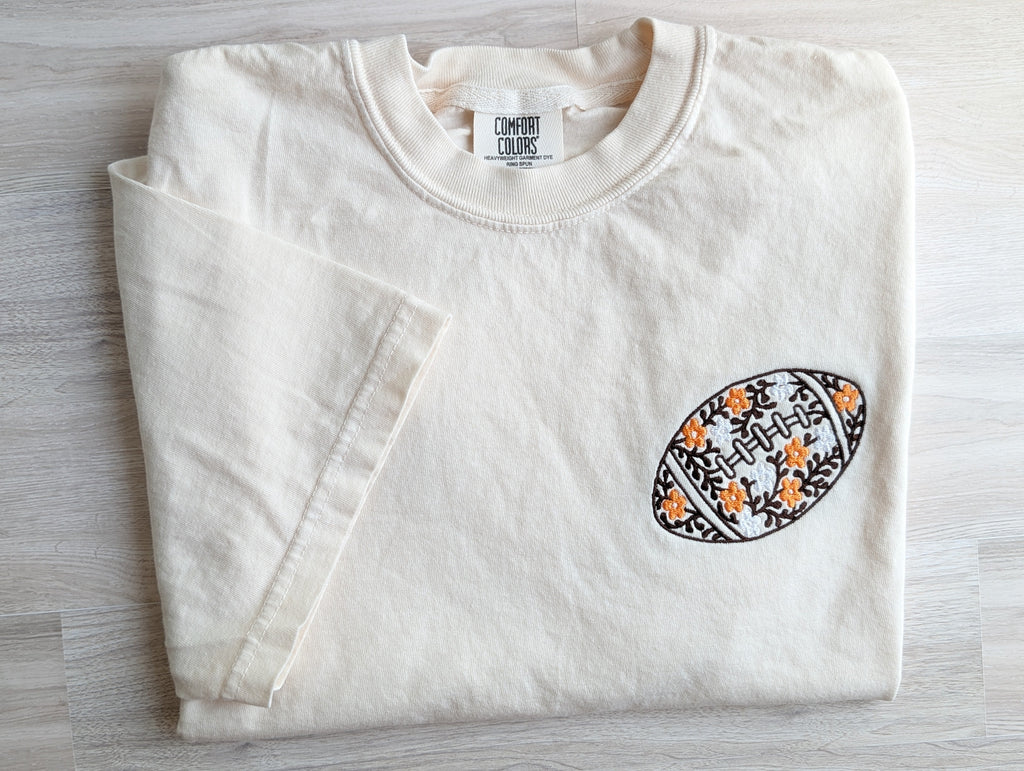 Close-up of floral football embroidery with orange flowers