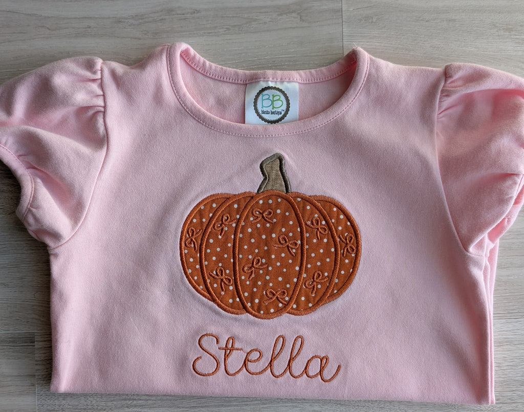 Pink ruffle hem cap sleeve shirt with fabric pumpkin appliqué and embroidered name