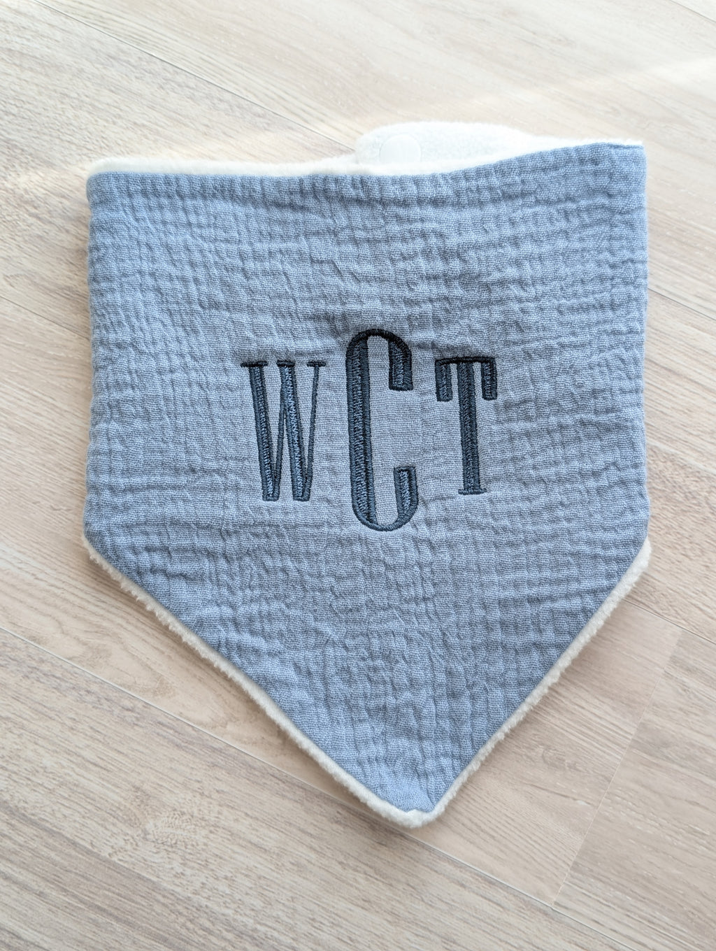 Gray personalized baby bib embroidered with a monogram