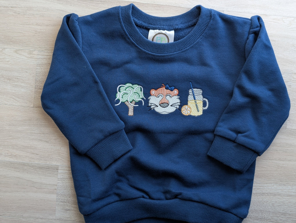 Blue sweatshirt with oak tree, tiger, and lemonade embroidery shown flat