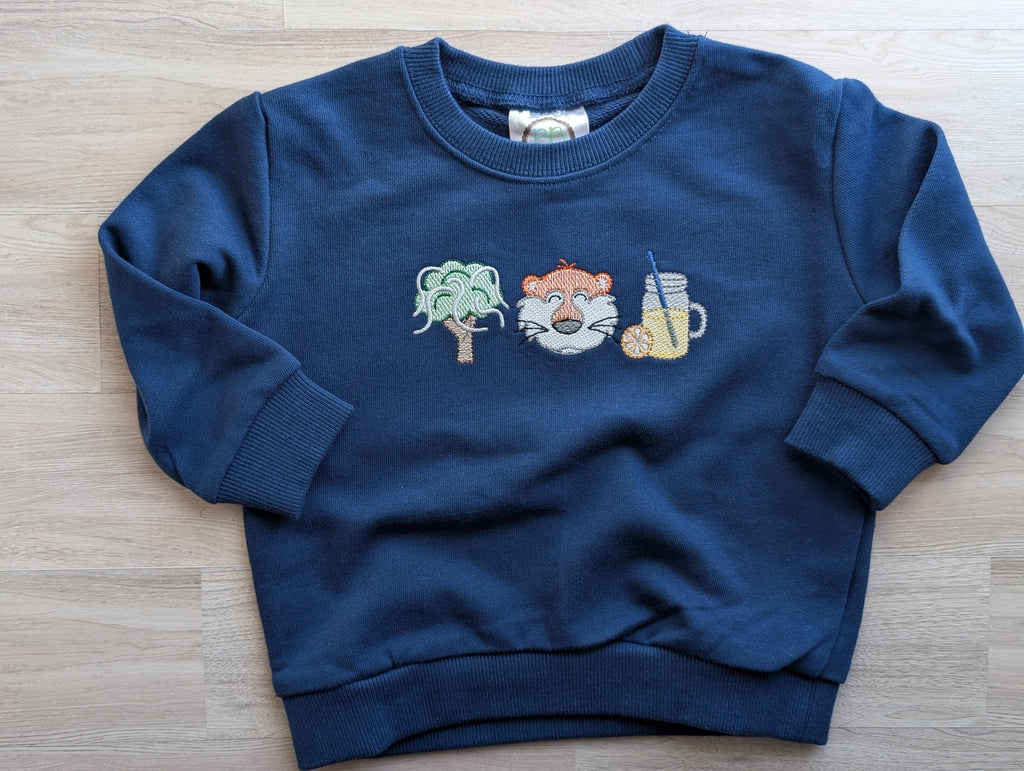 Blue sweatshirt featuring embroidered oak tree, tiger face, and lemonade designs