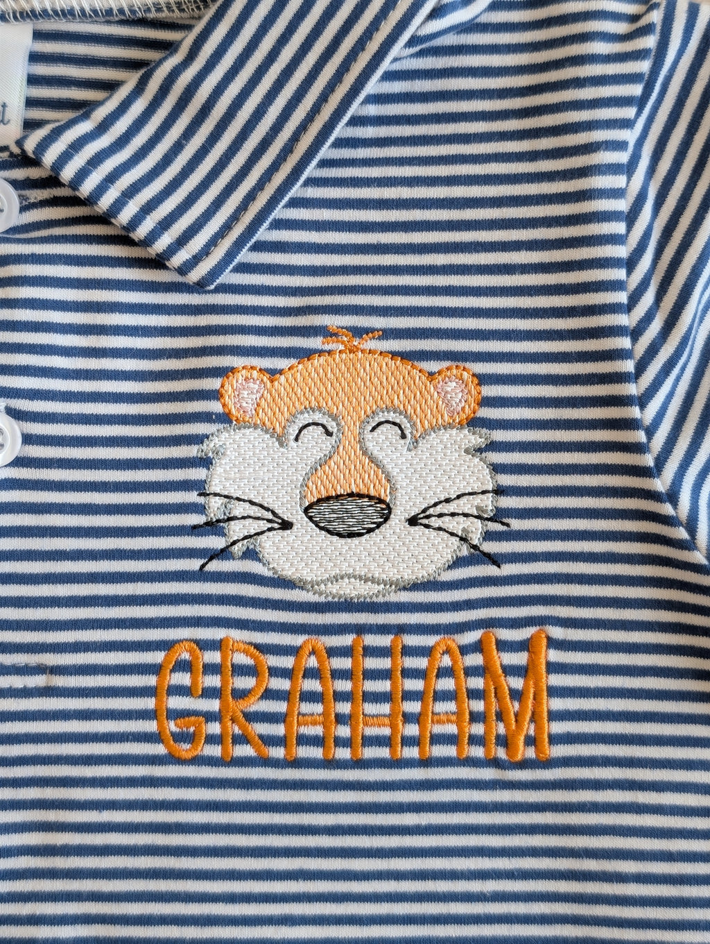 Close-up of tiger mascot and Graham name embroidery on striped polo