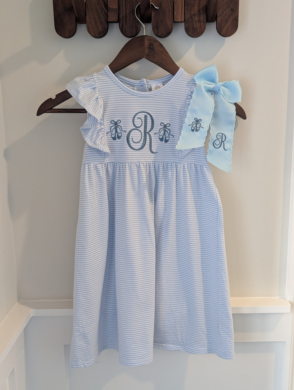 Personalized blue ballet slipper dress pictured with a coordinating bow