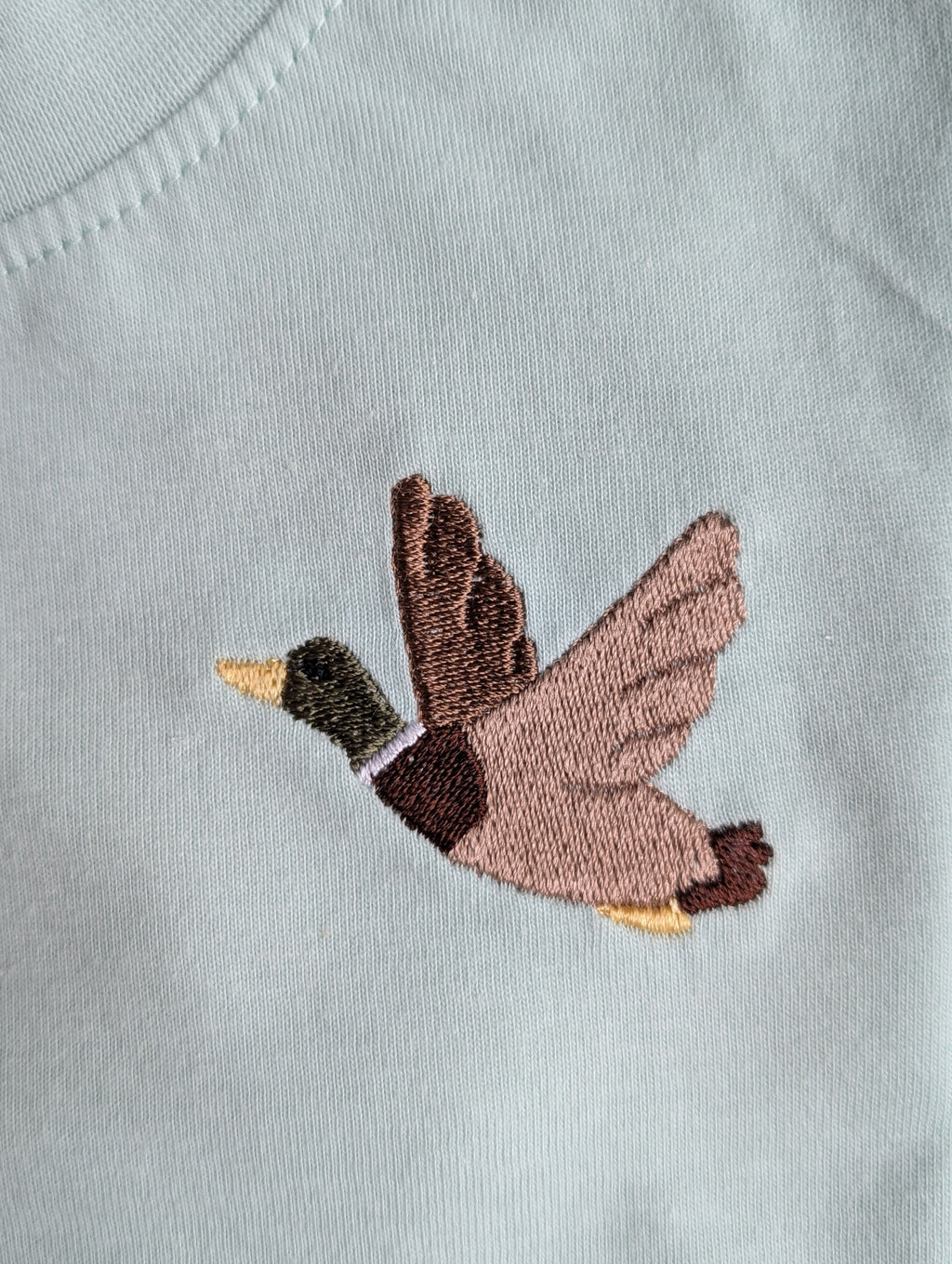 Embroidered animal detail on long-sleeve shirt