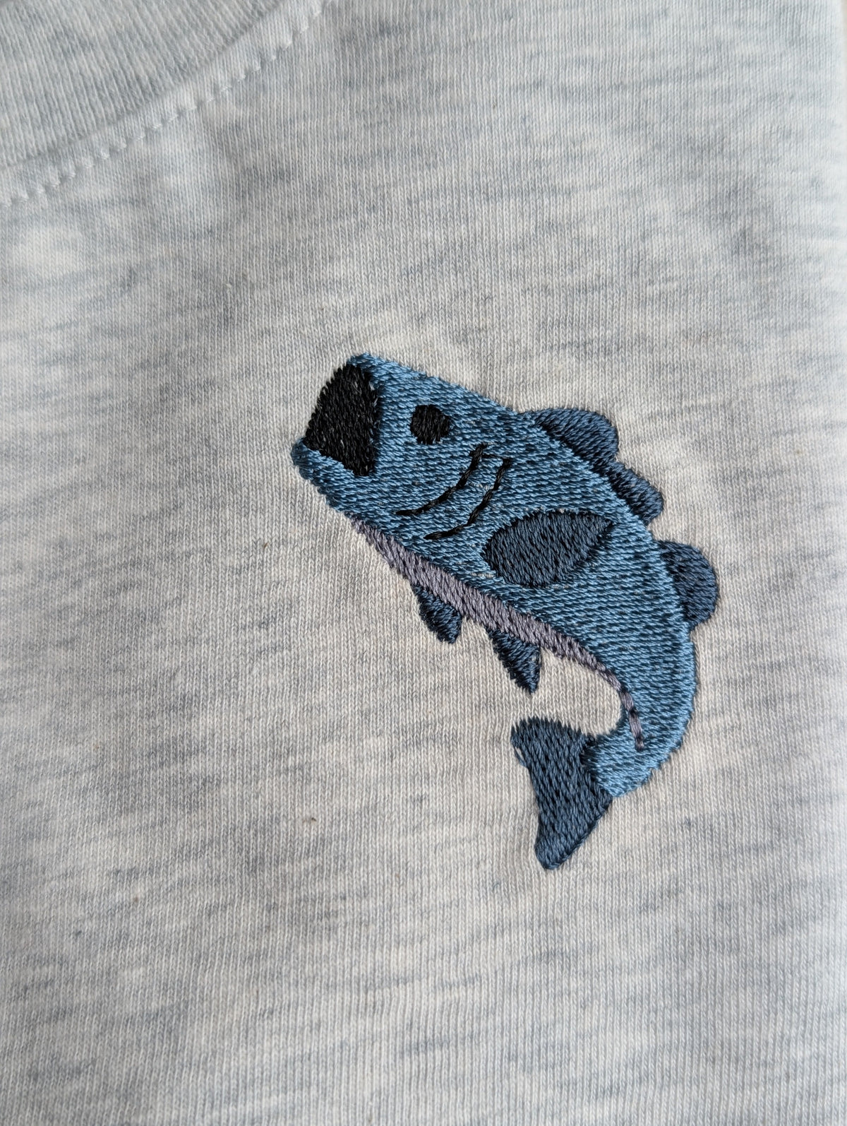 Close-up of animal embroidery on Frost Pack shirt