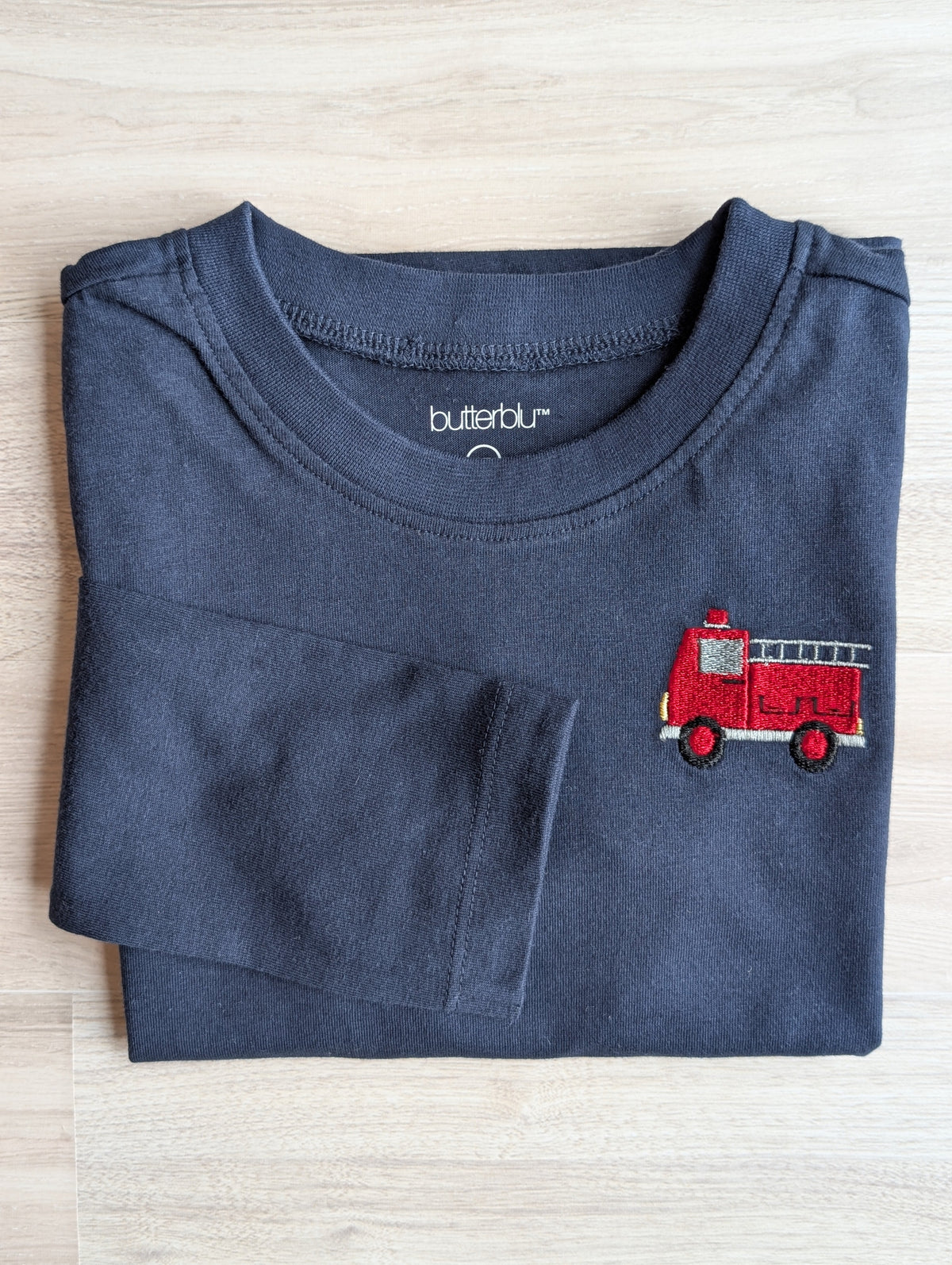 Embroidered vehicle detail on organic cotton long-sleeve shirt