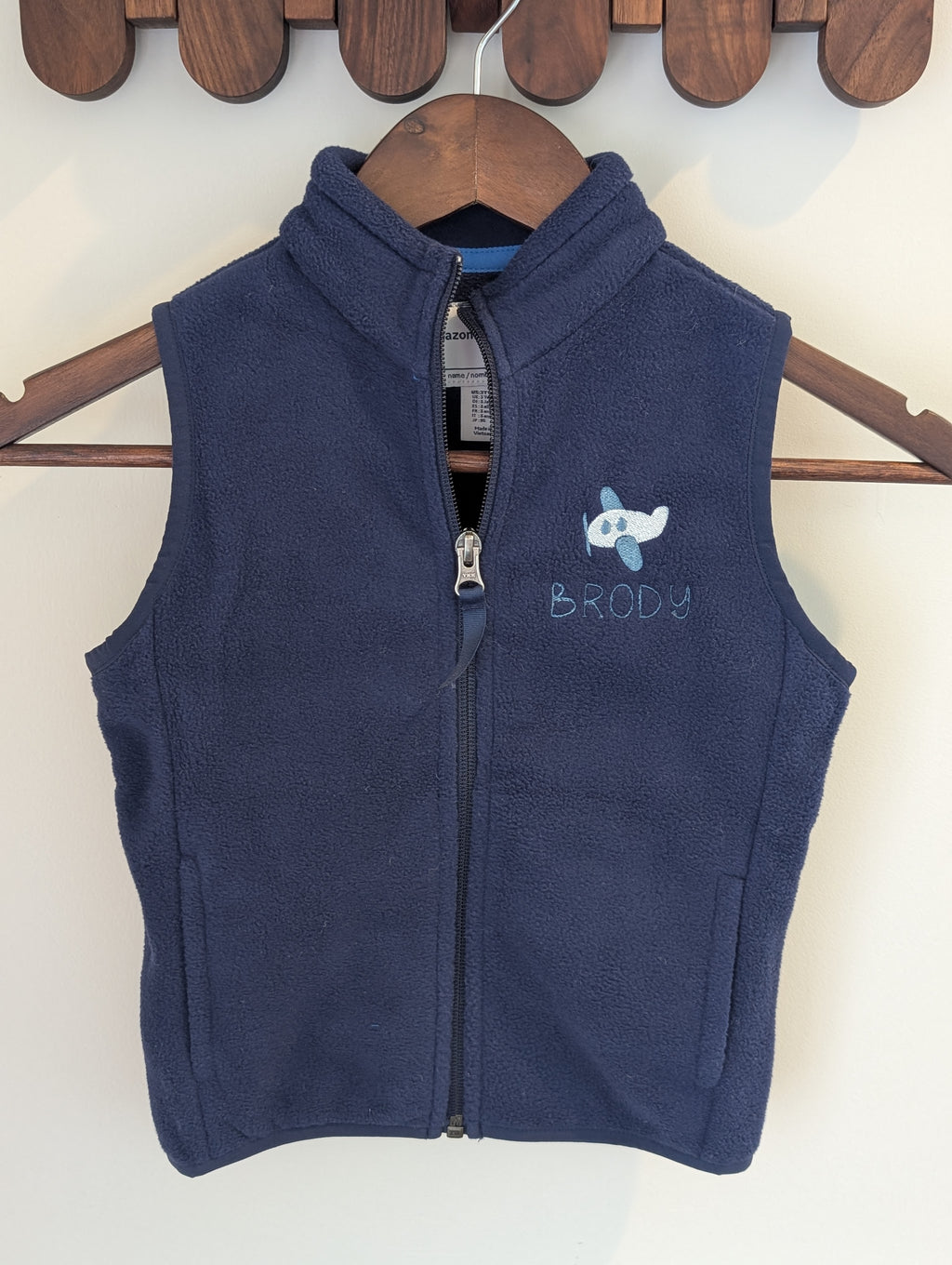 Navy fleece vest personalized with an airplane icon and Brody name