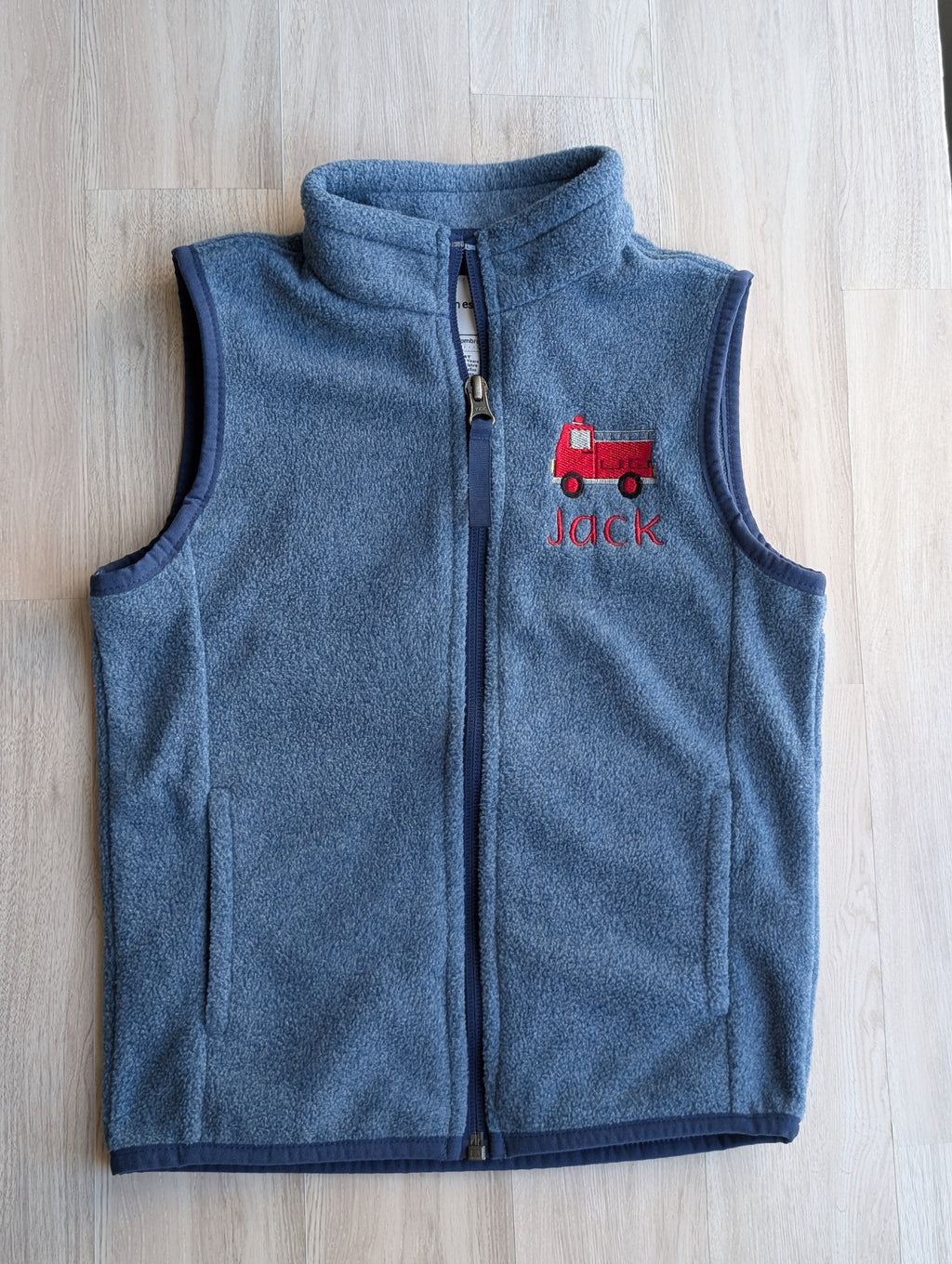 Close-up of red fire truck embroidery and Jack name on blue fleece