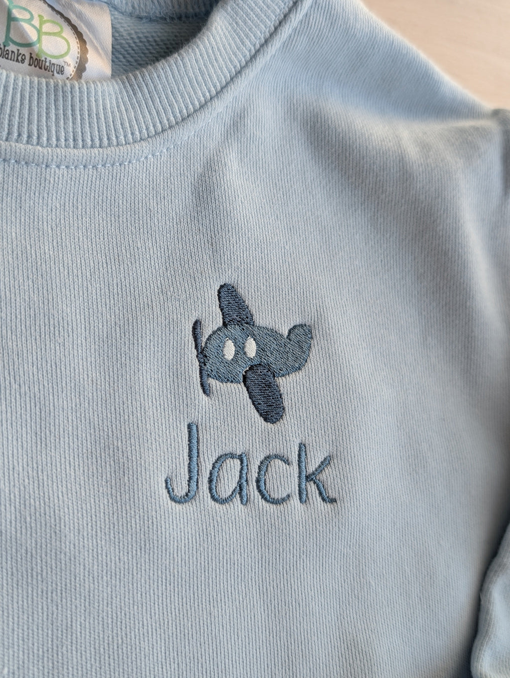 Navy and light blue personalized sweatshirts with script and print font examples